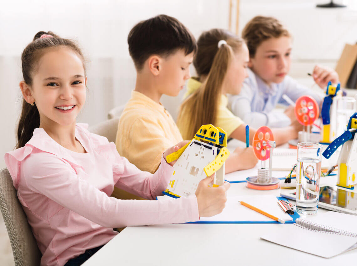 Stem education. Girl creating robot at lab