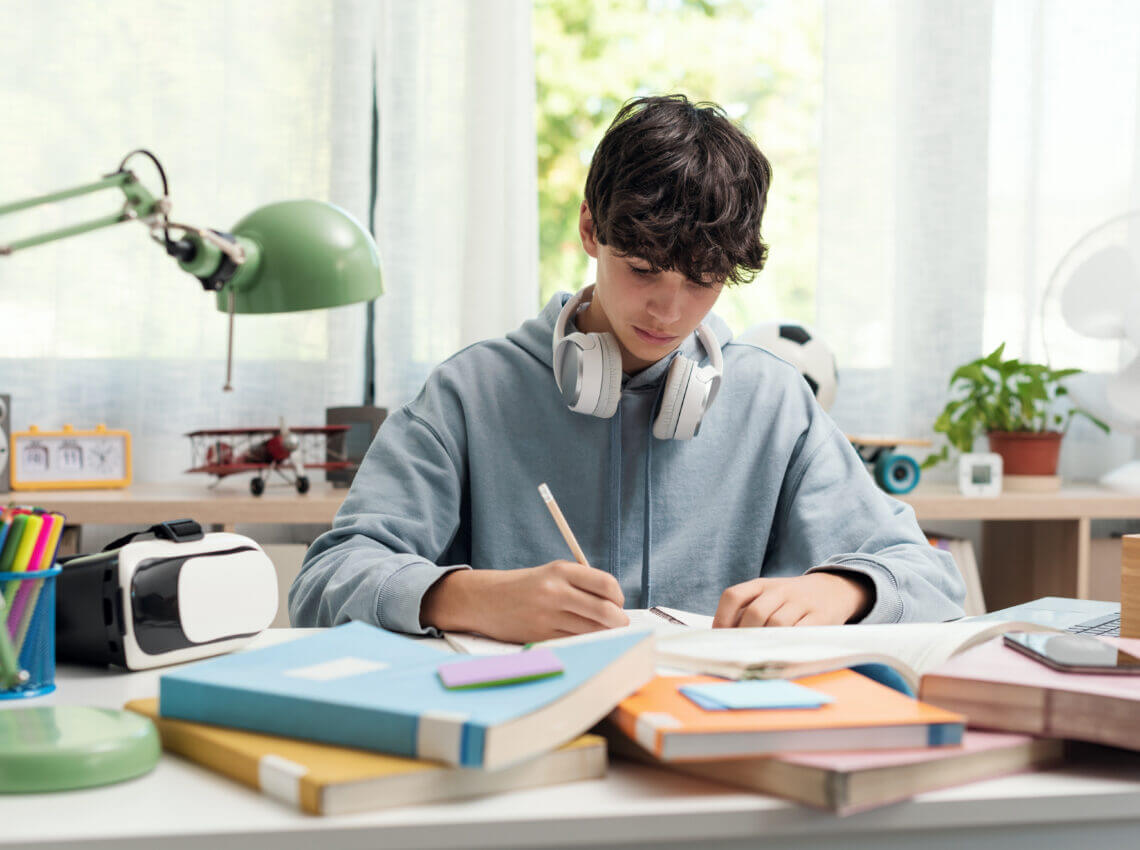 Teenager studying at home alone